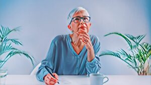 image showing older woman thinking. represents article on COMT and APOE in memory and aging